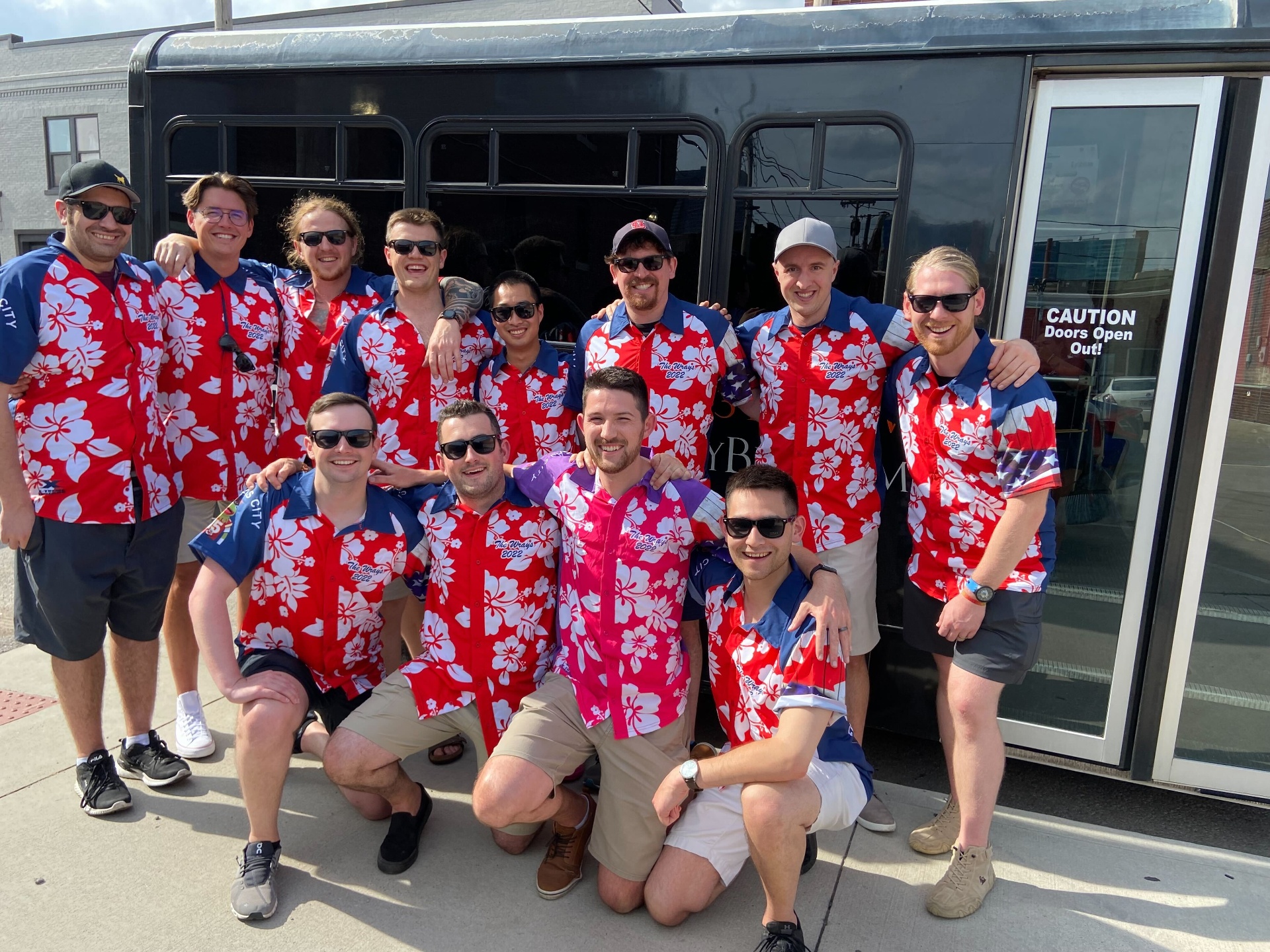Bachelor party group in matching shirts in front of Barley Bus
