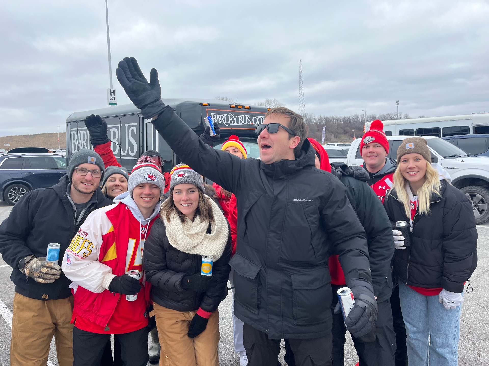 Friends celebrating outside Barley Bus at a Chiefs tailgate