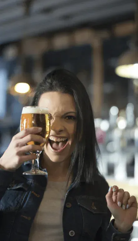 Woman enjoying a craft beer on a Barley Bus brewery tour